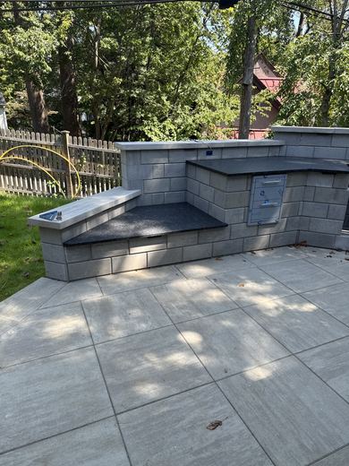 Outdoor kitchen with granite countertops on a paver patio, in progress, RDH Construction