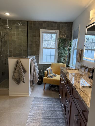 Master bath with green tile shower and wood vanity, remodel by RDH Construction