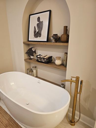 Freestanding tub and arched shelf niche, bathroom remodel by RDH Construction