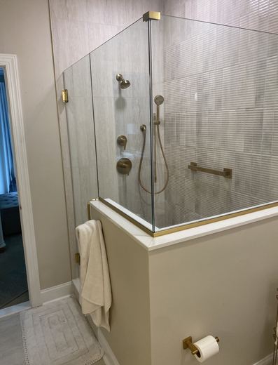 Glass shower with brass fixtures, bathroom remodel by RDH Construction