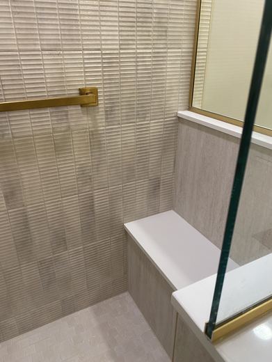 Shower bench and textured wall tile, bathroom remodel by RDH Construction