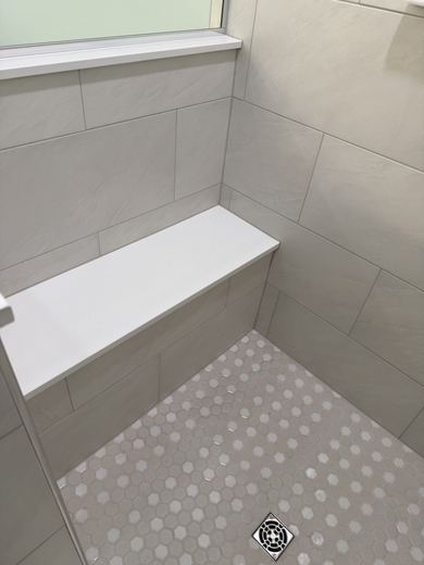 Shower bench and hex tile floor, remodel by RDH Construction