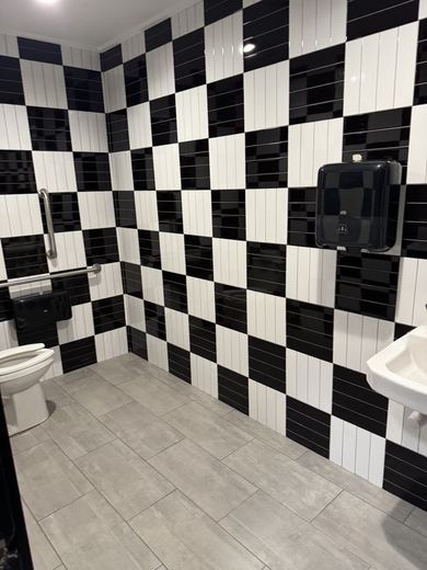 Black and white tiled restroom, commercial project by RDH Construction